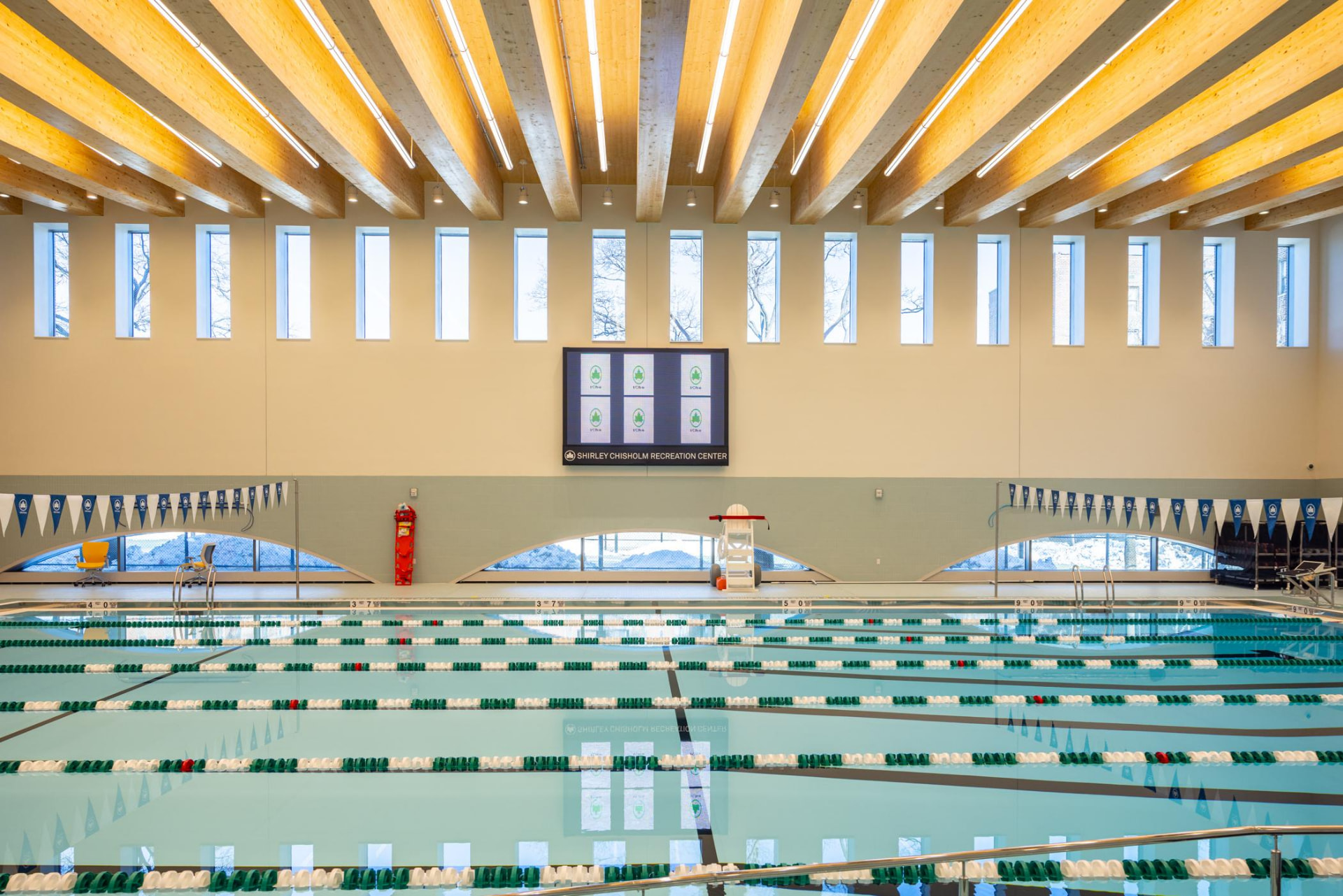 Image: The center's competition pool beneath mass-timber beams — supplied to WAAR