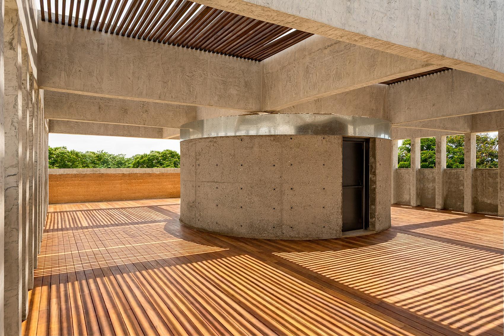 Image: Rooftop terrace beneath the concrete pergola — courtesy of Adjaye Associates